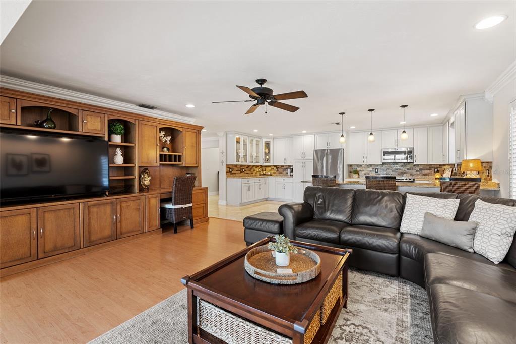 657 Riviera Bay Drive Northeast St. Petersburg, FL 33702 - Photo 14 of 50 a living room with furniture kitchen view and a flat screen tv