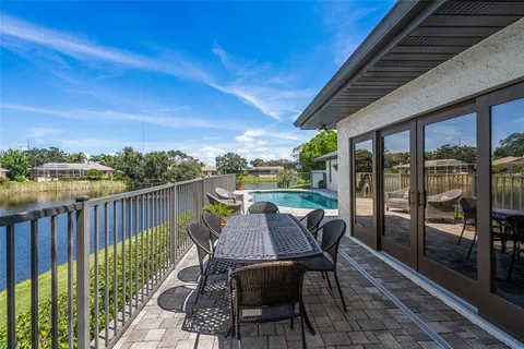 a view of a chairs and table in the balcony