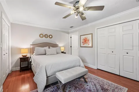 a bedroom with a bed and a chandelier