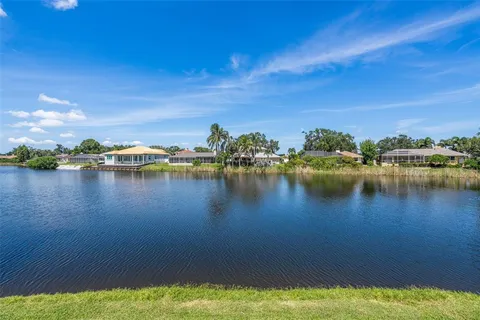 a view of a lake with houses in the back