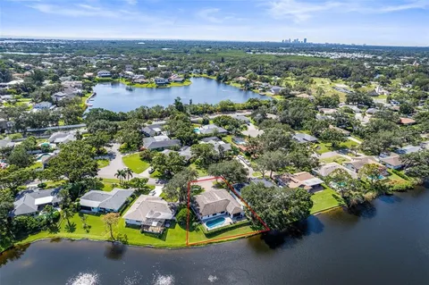 an aerial view of residential houses with outdoor space and lake view