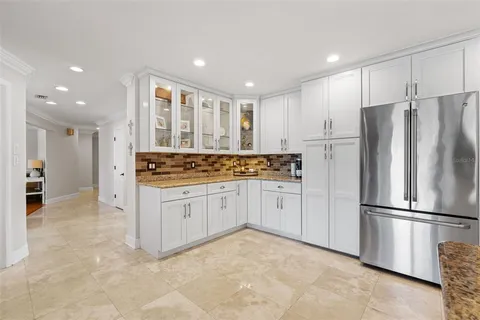 a kitchen with granite countertop cabinets and refrigerator