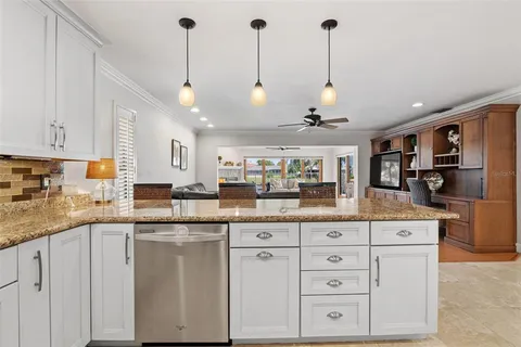 a kitchen with white cabinets and appliances