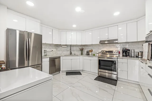 a kitchen with a white stove top oven and refrigerator