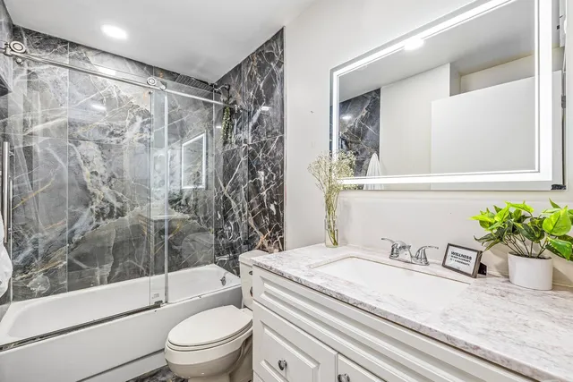 a bathroom with a sink toilet and shower