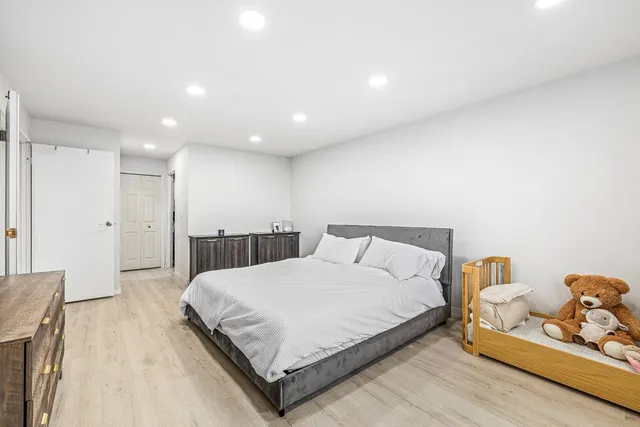 a spacious bedroom with a bed and a couch