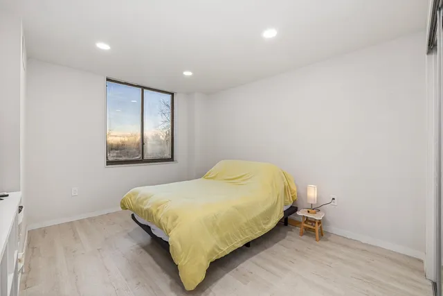 a bedroom with a bed and a table