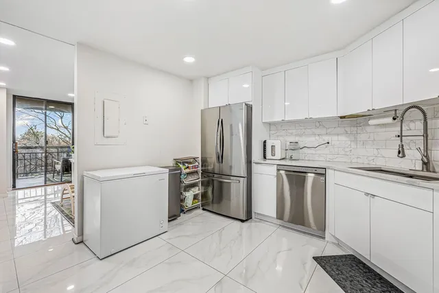 a kitchen with a refrigerator sink and stove