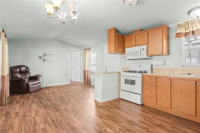a kitchen with a stove cabinets and wooden floor