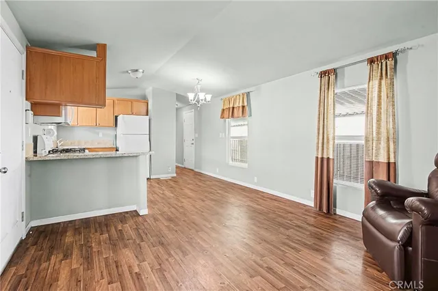 a view of kitchen with livingroom and wooden floor