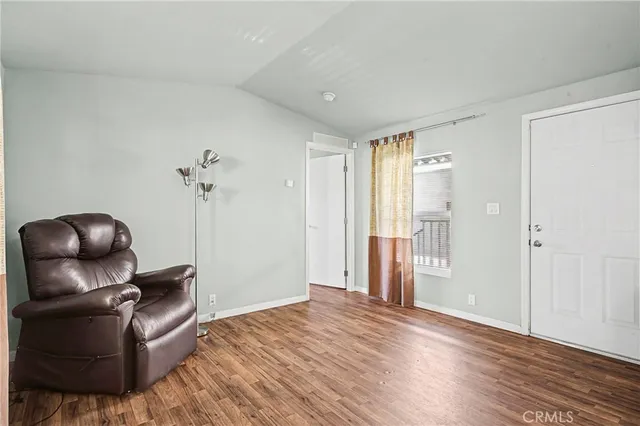 a room with wooden floor and furniture