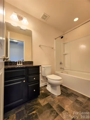 a bathroom with a toilet a sink and a mirror