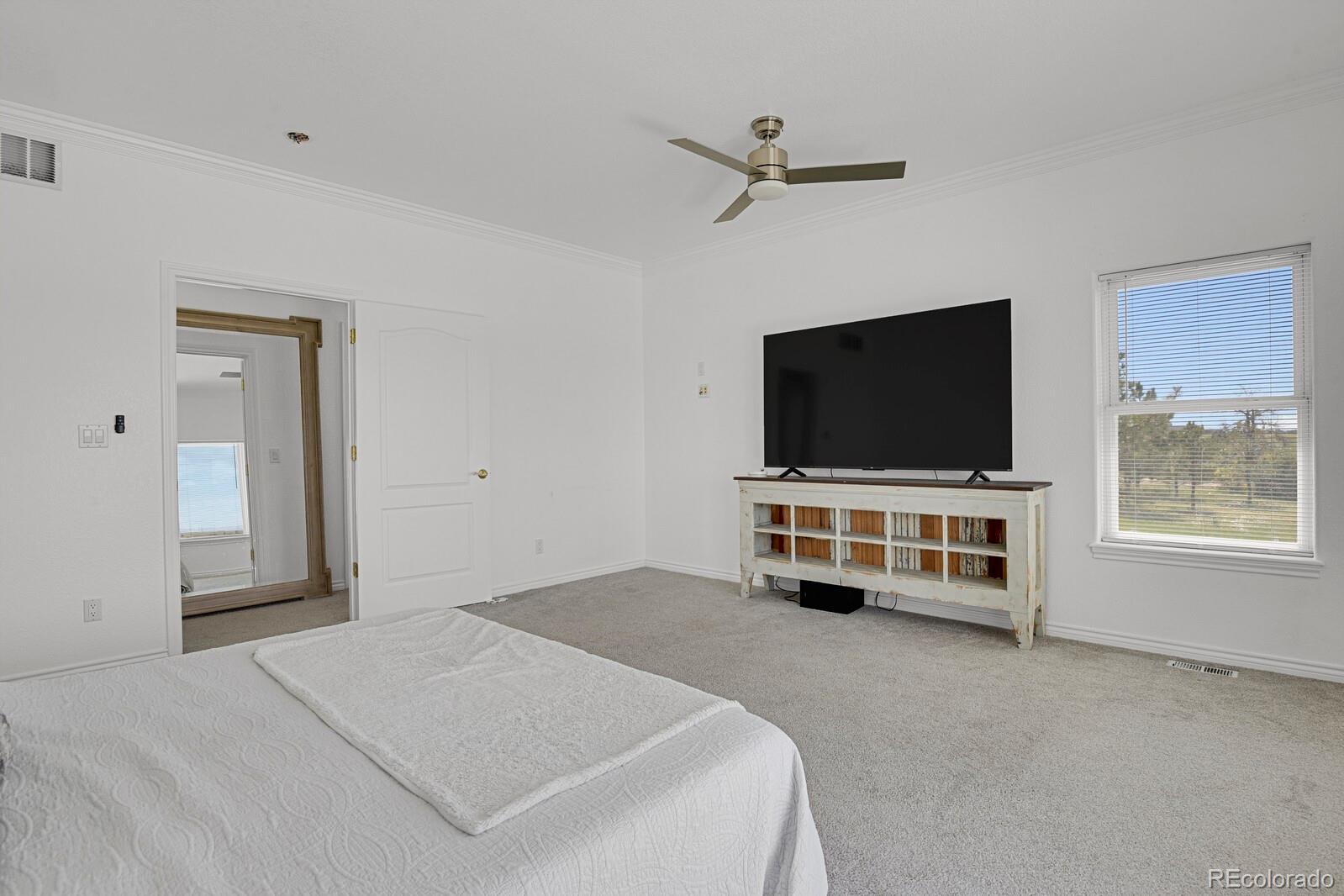 897 East Rim Road Franktown, CO 80116 - Photo 11 of 32 a living room with flat screen tv and gym equipment