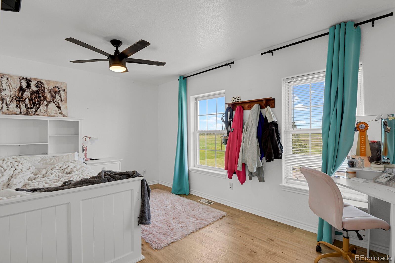 897 East Rim Road Franktown, CO 80116 - Photo 14 of 32 a bedroom with a bed and a window