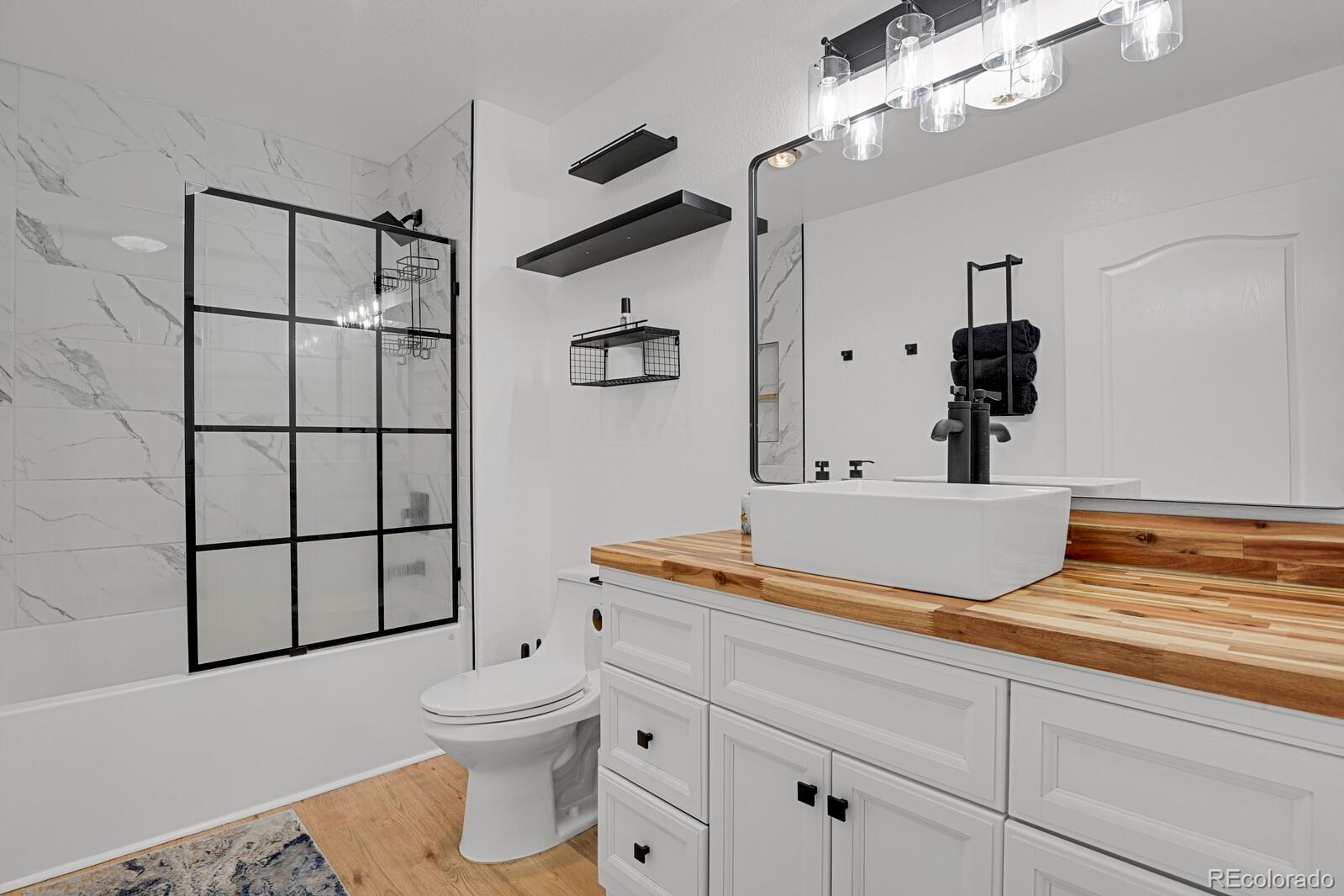 897 East Rim Road Franktown, CO 80116 - Photo 16 of 32 a bathroom with a sink a toilet and shower