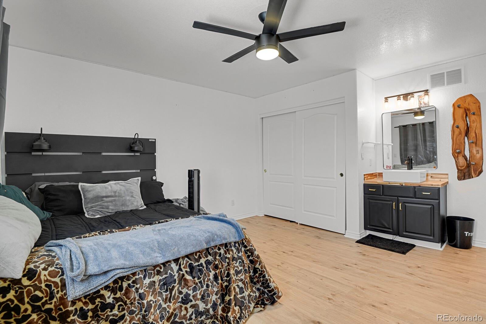 897 East Rim Road Franktown, CO 80116 - Photo 17 of 32 a bedroom with a bed and a flat screen tv