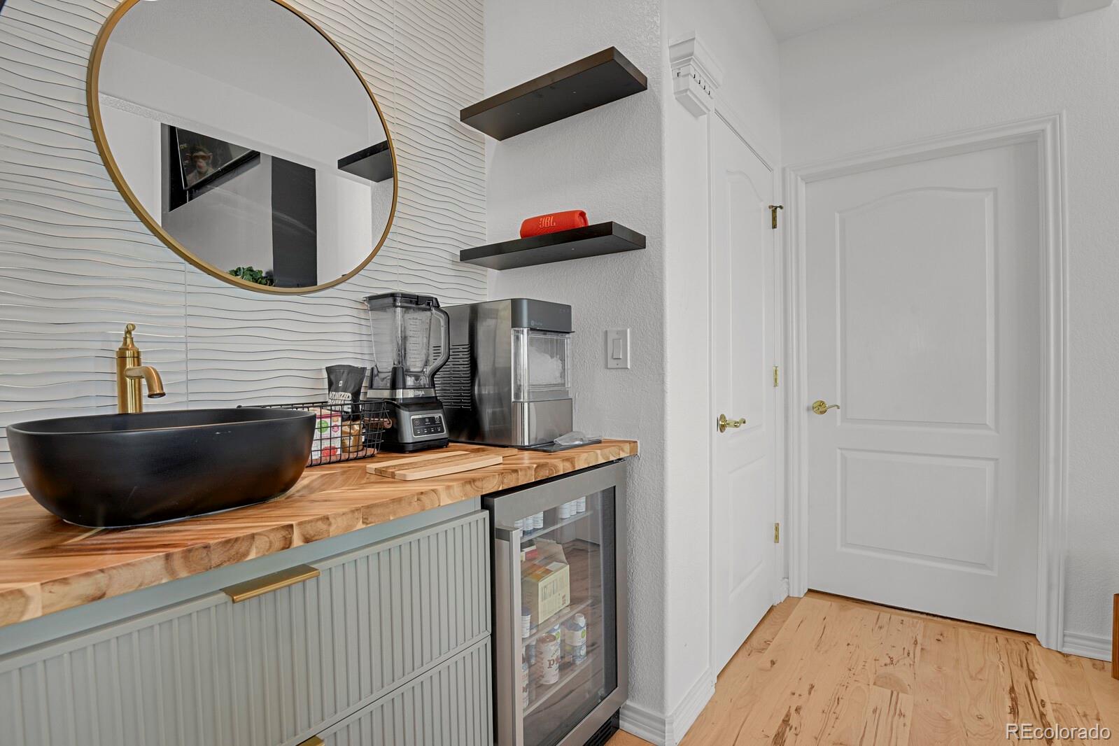 897 East Rim Road Franktown, CO 80116 - Photo 18 of 32 a kitchen with a sink and a mirror