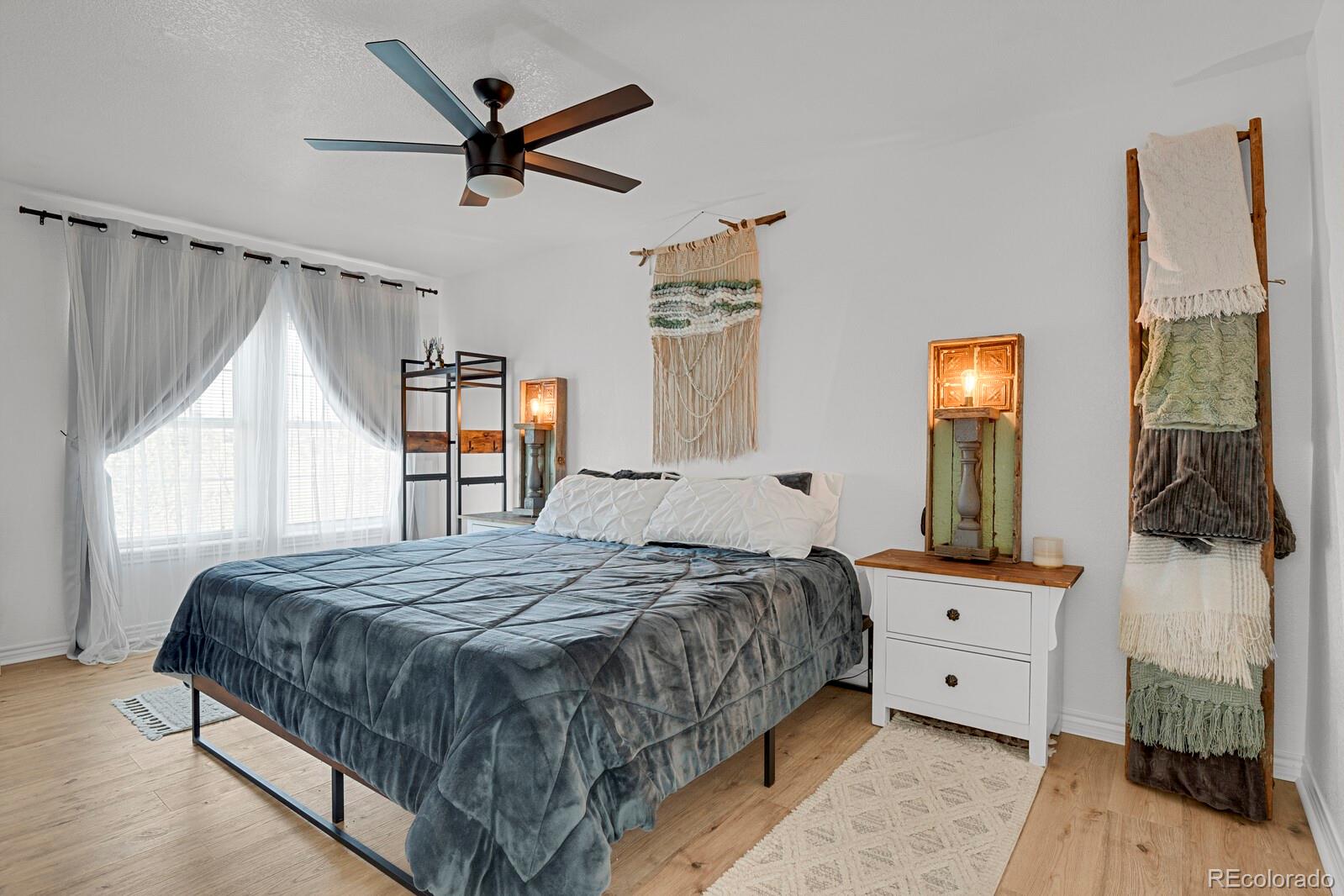 897 East Rim Road Franktown, CO 80116 - Photo 20 of 32 a bedroom with a bed a window and dresser