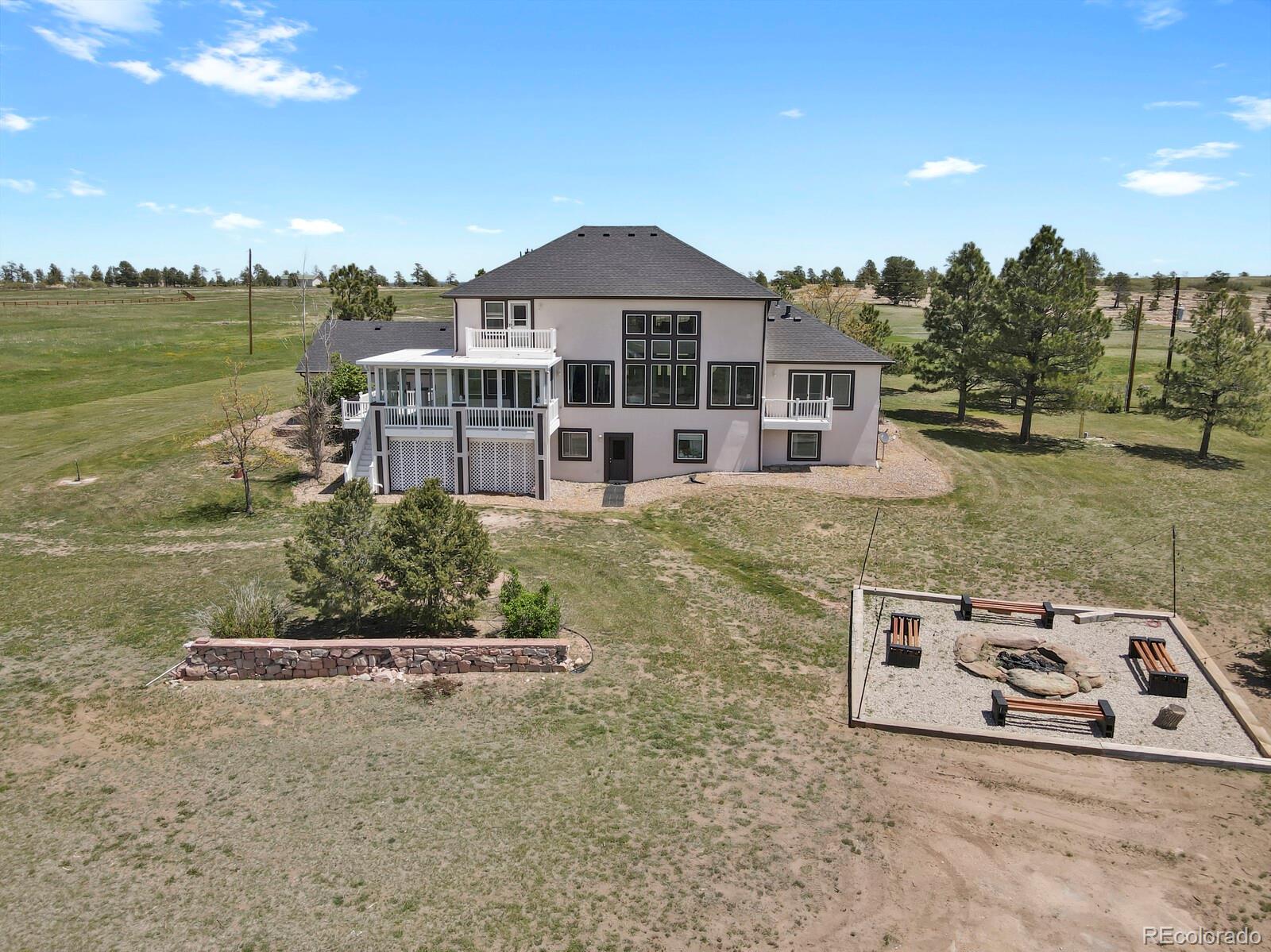 897 East Rim Road Franktown, CO 80116 - Photo 27 of 32 a front view of a house with a yard
