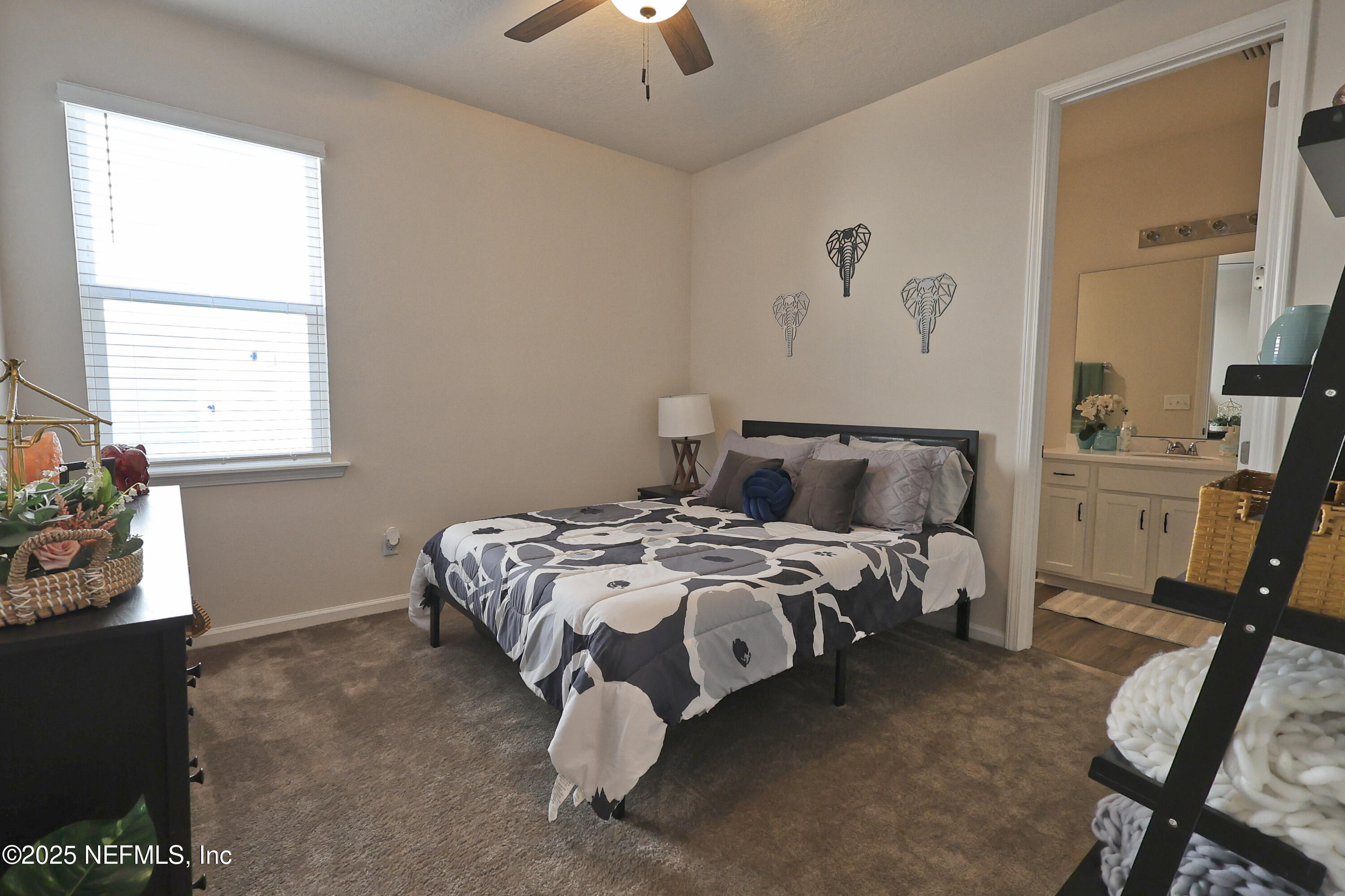 138 Lambert Road St. Johns, FL 32259 - Photo 24 of 50 a bed sitting in a bedroom next to a window