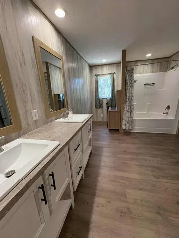 a bathroom with a sink vanity and mirror