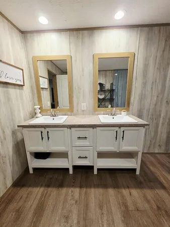 a bathroom with a sink vanity and mirror