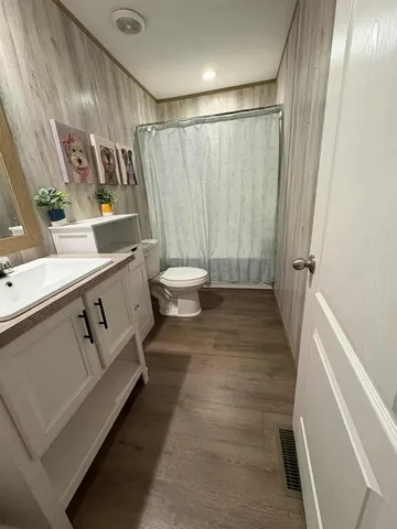 a bedroom with two beds and a desk