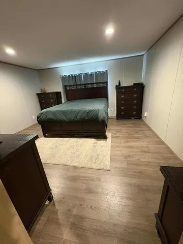 a bedroom with a bed and a couch