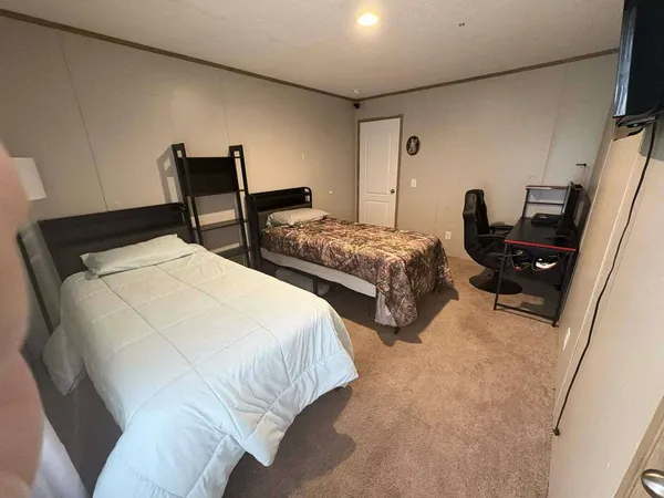 a bedroom with a bed and a couch