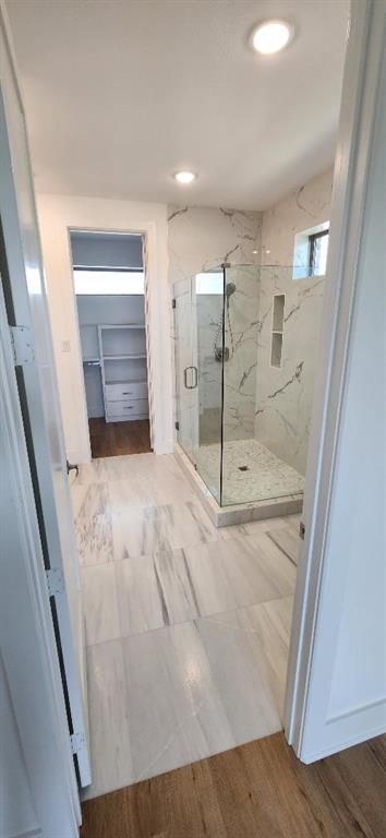 3338 Sylvan Avenue Dallas, TX 75212 - Photo 8 of 13 Bathroom with a marble finish shower, a spacious closet, wood finished floors, and recessed lighting