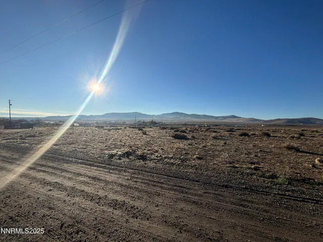 a view of a beach with a view of mountains