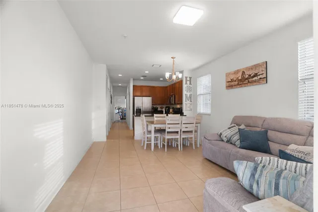 a living room with furniture and a dining room