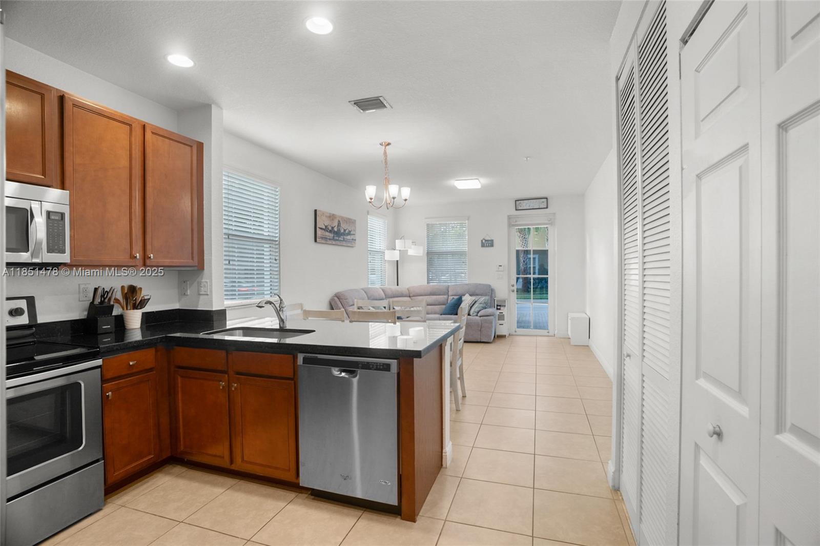 14774 Southwest 10th Street, Unit 10502 Pembroke Pines, FL 33027 - Photo 16 of 40 a kitchen with a sink and cabinets