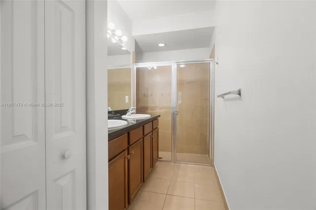 a bathroom with a double vanity sink and mirror