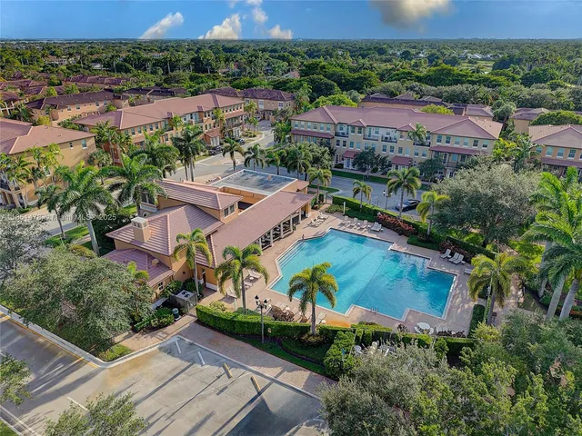 an aerial view of residential house with outdoor space and swimming pool