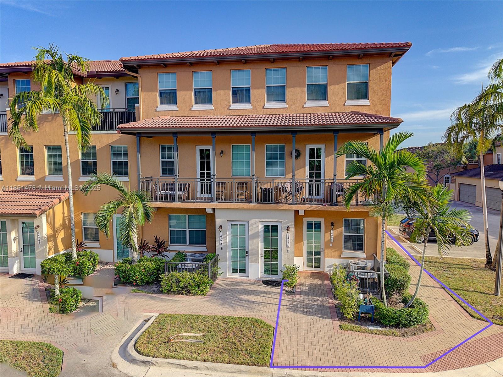14774 Southwest 10th Street, Unit 10502 Pembroke Pines, FL 33027 - Photo 3 of 40 a front view of a residential apartment building with a yard