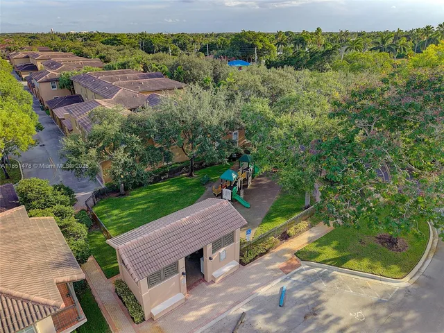 an aerial view of a house with a yard