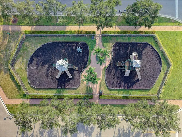 an aerial view of a house with garden space and a swimming pool