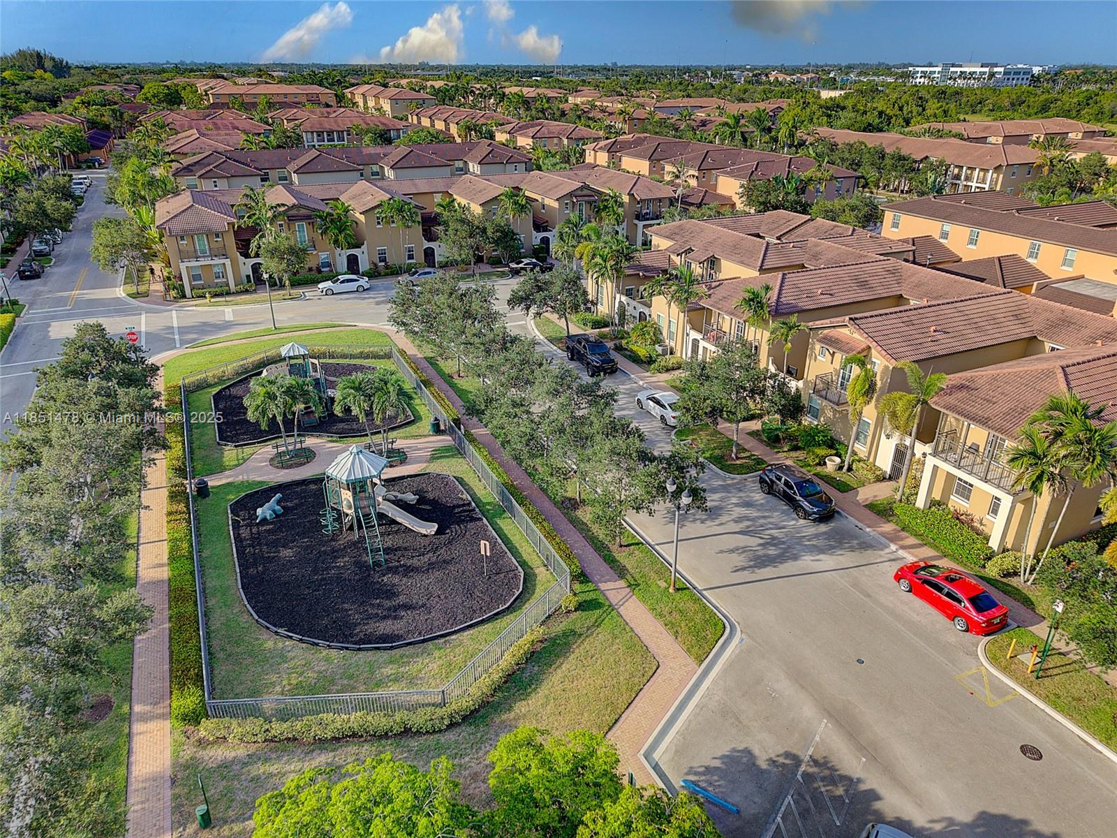 14774 Southwest 10th Street, Unit 10502 Pembroke Pines, FL 33027 - Photo 38 of 40 a view of a swimming pool with a patio and a yard