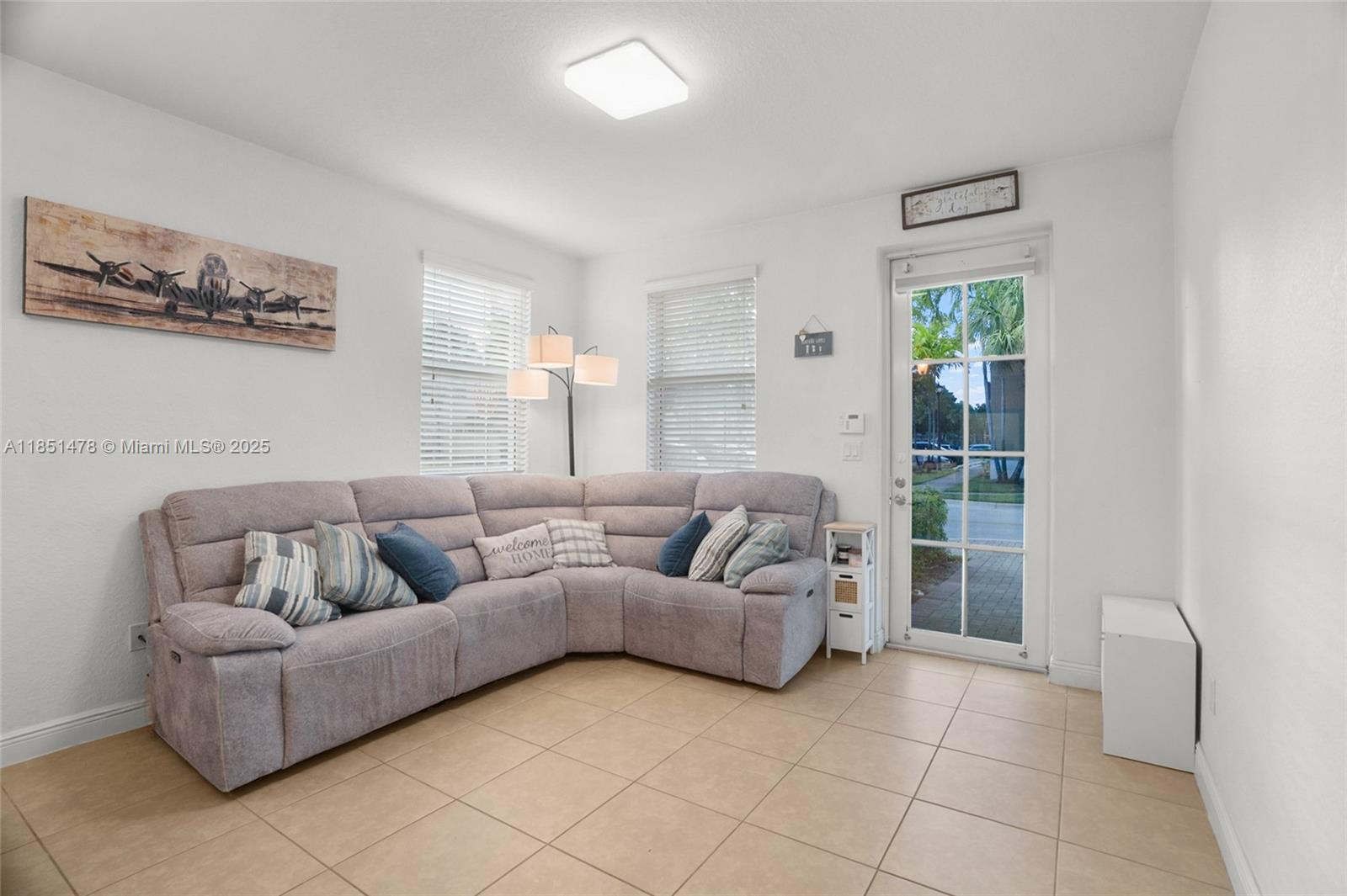 14774 Southwest 10th Street, Unit 10502 Pembroke Pines, FL 33027 - Photo 8 of 40 a living room with furniture and a window