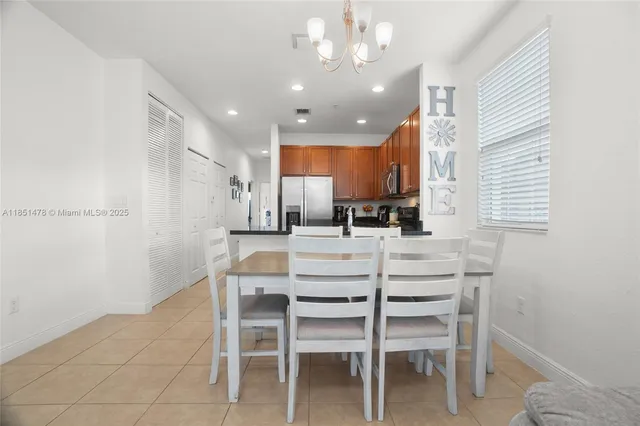 a kitchen with kitchen island cabinets and chairs in it