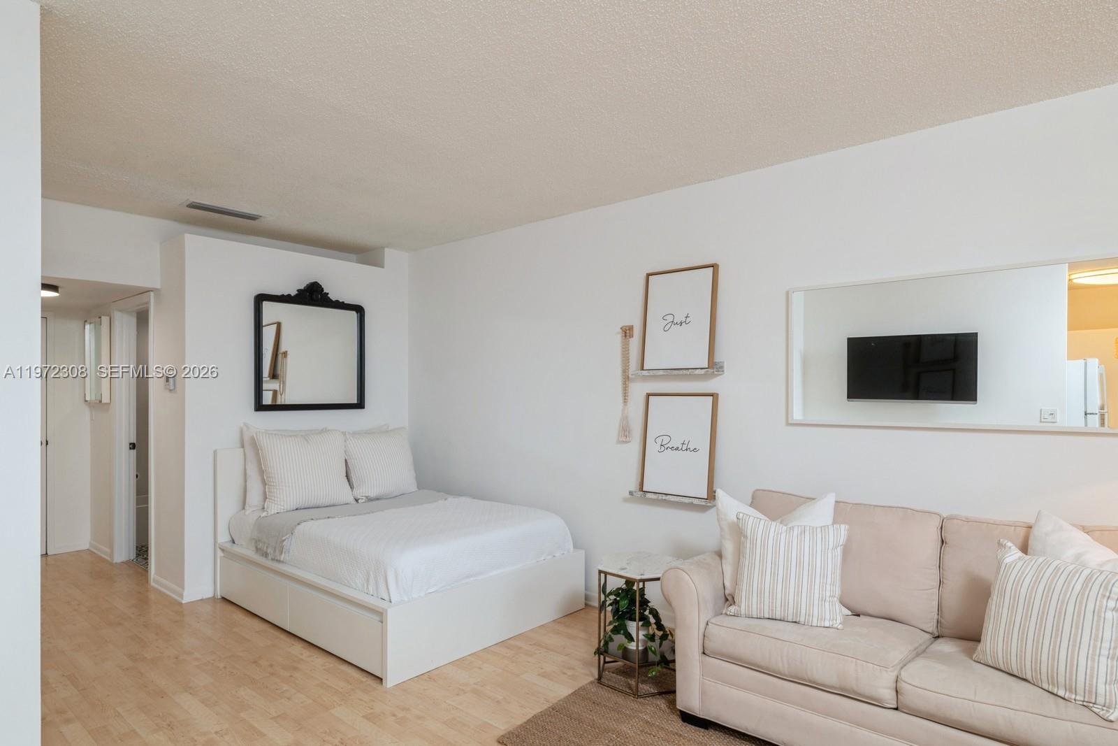 540 Brickell Key Drive, Unit 504 Miami, FL 33131 - Photo 13 of 31 a living room with furniture and a flat screen tv