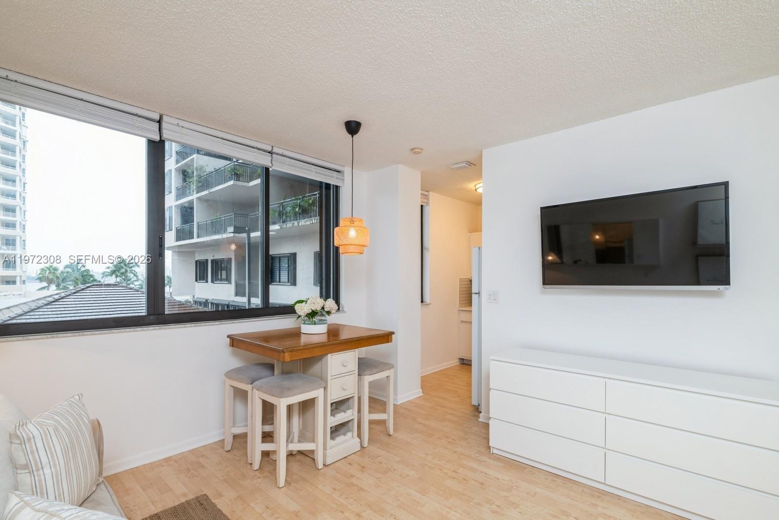 540 Brickell Key Drive, Unit 504 Miami, FL 33131 - Photo 15 of 31 a dining room with furniture and wooden floor