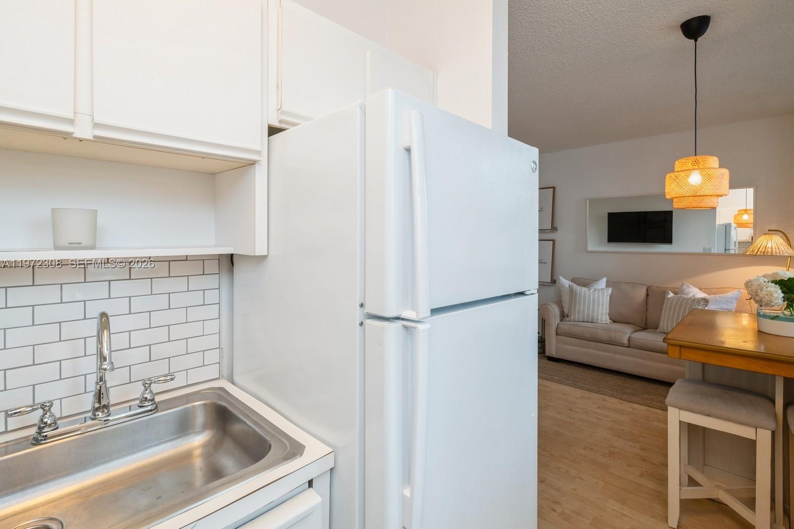 540 Brickell Key Drive, Unit 504 Miami, FL 33131 - Photo 23 of 31 a white refrigerator freezer sitting inside of a kitchen
