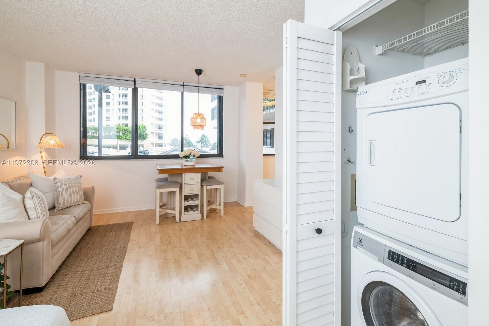 540 Brickell Key Drive, Unit 504 Miami, FL 33131 - Photo 25 of 31 a living room with furniture and a large window