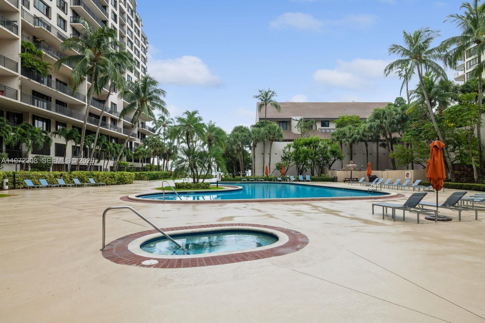 540 Brickell Key Drive, Unit 504 Miami, FL 33131 - Photo 6 of 31 a view of a swimming pool with a patio and plants