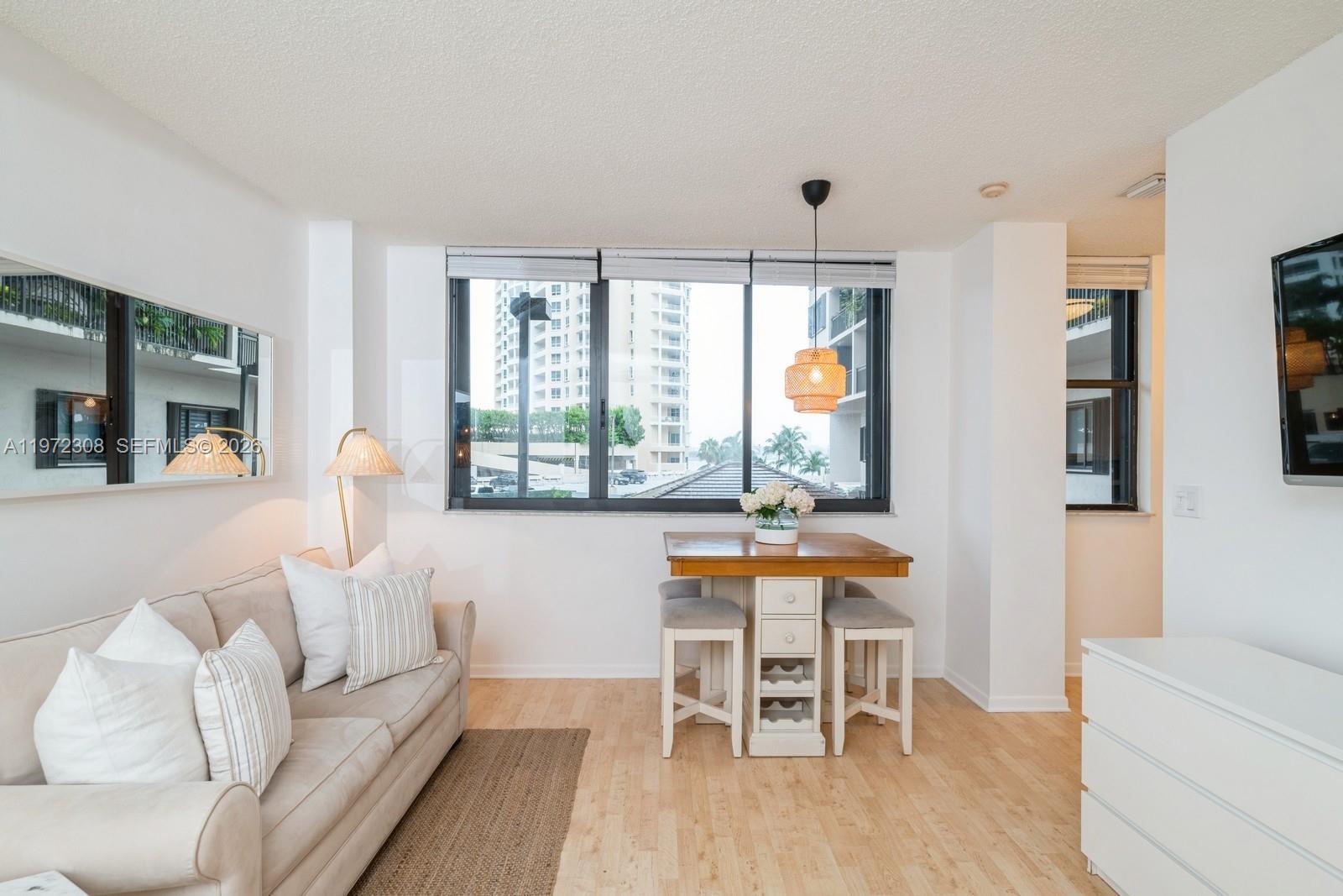 540 Brickell Key Drive, Unit 504 Miami, FL 33131 - Photo 10 of 31 a living room with furniture and a large window
