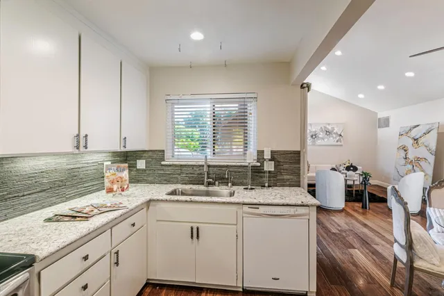 a kitchen with a sink stove and cabinets
