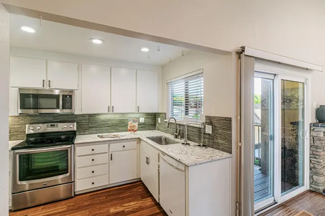 a kitchen with a stove a sink and a refrigerator