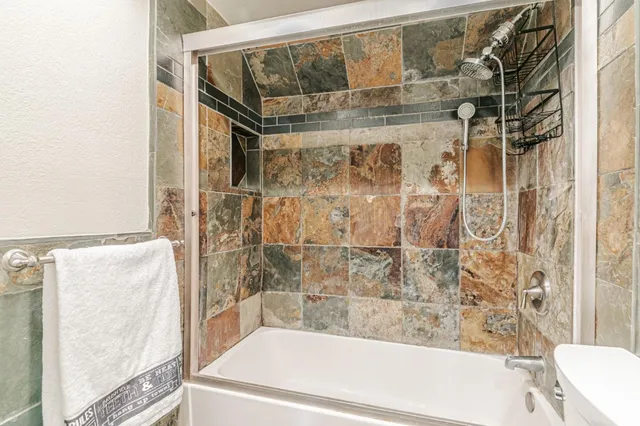 a bathroom with a bathtub and shower